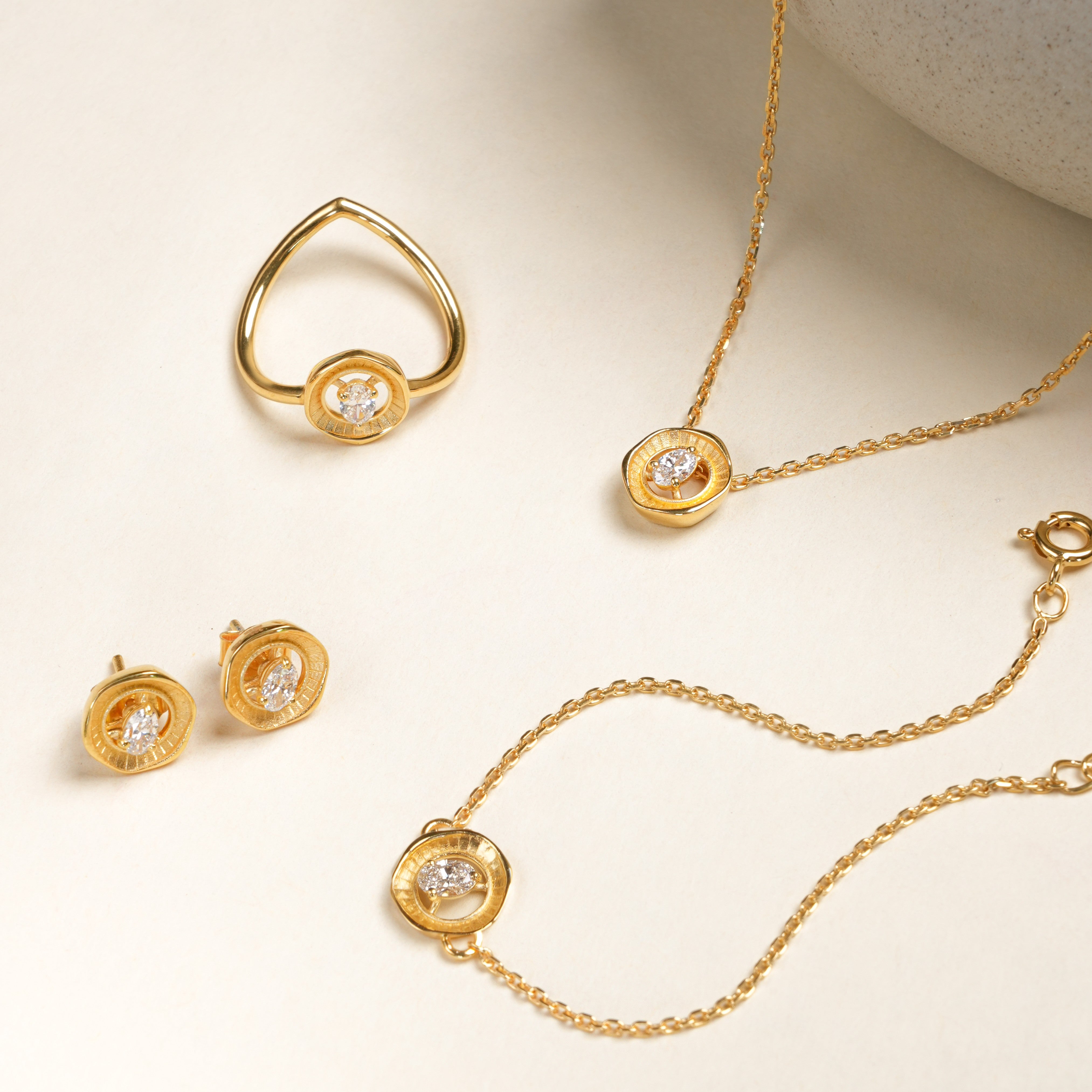 Flatlay of Averra bracelet along with the averra collection with lab grown diamonds in 24KT gold micron plated finish